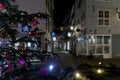 Illuminated Christmas tree and decorated street in Maastricht in the Stokstraat quarter. Wishing customers and tourist a happy hol