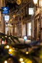 Illuminated Christmas tree and decorated street in Maastricht in the Stokstraat quarter. Wishing customers and tourist a happy hol