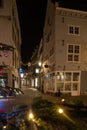 Illuminated Christmas tree and decorated street in Maastricht in the Stokstraat quarter. Wishing customers and tourist a happy hol