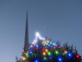 Illuminated Christmas tree with glowing light and the Spire monument in the background. Christmas time in Dublin city, the capital Royalty Free Stock Photo
