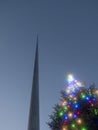 Illuminated Christmas tree with glowing light and the Spire monument in the background. Christmas time in Dublin city, the capital Royalty Free Stock Photo