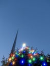 Illuminated Christmas tree with glowing light and the Spire monument in the background. Christmas time in Dublin city, the capital Royalty Free Stock Photo