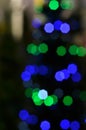 Illuminated Christmas tree on indistinct, blurred background.