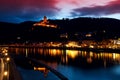 Illuminated city and castle close to river