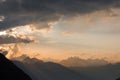Illuminated clouds in the mountains with rays of sunshine shining trought the clouds; Alps; Royalty Free Stock Photo