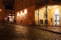 Illuminated cobbled street by late evening , Vienna.