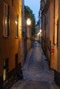 Illuminated cobbled street in the old town of Stockholm, Sweden at dusk Royalty Free Stock Photo