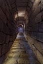 Illuminated corridor of stone blocks and rock stairs from the exit of the water algive of the Arab citadel of Merida. Royalty Free Stock Photo