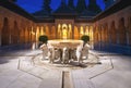 Court of the Lions (Patio de los Leones) with fountain at Nasrid Palaces of Alhambra at night - Granada, Spain