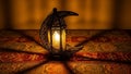 Illuminated Crescent Lantern on Patterned Fabric Royalty Free Stock Photo