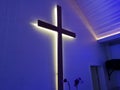 Illuminated Cross Mounted On The Wall Of Modern Church