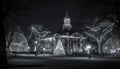 Illuminated cross in old city, symbolizing Christianity generated by AI