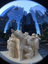 The Illuminated Crowd in front of reflective glass buildings