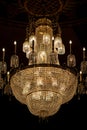 An illuminated crystal chandelier in a dark room