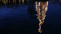 Illuminated decorated New Year tree reflected in the water