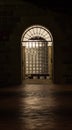 Illuminated doorway with arch and clear glass bricks at night