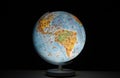 Illuminated earth globe in the form of a desk or table night light, glowing in the dark, no people