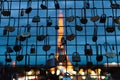 Illuminated Eiffel Tower is seen at night behind fence filled with locks and lockers with heart shapes in Paris, France. Concept
