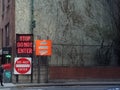 Stop do not enter road signs with large exterior building wall