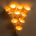 Illuminated Elegance A Cluster of Cone Shaped Wall Sconces Casting Warm Light and Shadow, Creating a Cozy and Inviting Ambiance in Royalty Free Stock Photo