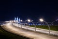 Illuminated empty highway at night