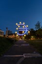 An Illuminated Euro symbol with blue lights and yellow stars at night in Frankfurt am Main, Germany