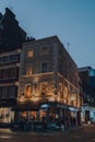 Illuminated exterior of Coach and Horses pub in 18th-century building in Soho, London, UK