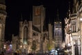 Illuminated facade of Saint Nicholas` Church Sint-Niklaaskerk with the clock tower of Belfry of Ghent Het Belfort at the Royalty Free Stock Photo