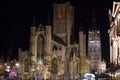 Illuminated facade of Saint Nicholas` Church Sint-Niklaaskerk with the clock tower of Belfry of Ghent Het Belfort at the Royalty Free Stock Photo