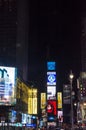 Illuminated facades of Broadway stores and theaters