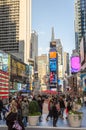 Illuminated facades of Broadway stores and theaters