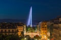 Illuminated Geneva Water Fountain Jet d`Eau - the city`s most famous landmark - summer evening view with blue sky, Geneva,