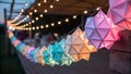 Illuminated geometric paper lanterns adorn outdoor space Royalty Free Stock Photo