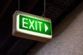 Illuminated green exit sign with an arrow