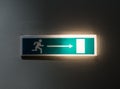 The illuminated green exit sign in dark room Royalty Free Stock Photo