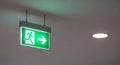 Illuminated Green Exit Sign with Running Man Symbol emergency exit safety Royalty Free Stock Photo
