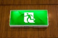 Illuminated green exit sign suspended from the ceiling Royalty Free Stock Photo