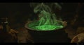 Illuminated green glowing cauldron emitting smoke in a dark mystical setting Royalty Free Stock Photo