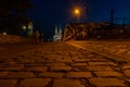 Illuminated Hohenzollern Arch Bridge walkway with a view of a cathedral in Cologne, Germany at night Royalty Free Stock Photo