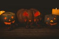 Illuminated jack o lantern with candles on table during Halloween