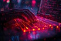 closeup of hands typing on illuminated keyboard with red and purple digital code overlay in dark environment with neon lights Royalty Free Stock Photo