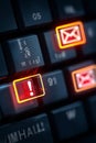 Illuminated keyboard keys with email and alert symbols suggest urgent communication or critical notifications within digital Royalty Free Stock Photo