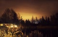 Illuminated lake in the forest at night.