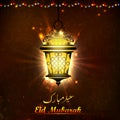 Illuminated lamp on Eid Mubarak background