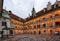 Illuminated Landhaus courtyard with a bronze fountain at sunset. Graz, Austria