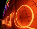 Illuminated letters and words made with neon lights and LEDs of many colors with a vanishing point in the background. Wires and