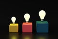 Illuminated light bulbs on colorful cubes. Creative idea development. Creative thinking, innovation and brainstorming Royalty Free Stock Photo