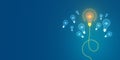 Illuminated lightbulbs on blue background, one bright bulb connected with a line represents a concept of a standout idea in a Royalty Free Stock Photo