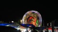 Illuminated lights of swings, long shutter of Ferris wheel Royalty Free Stock Photo