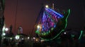 Illuminated lights of swings, long shutter of Ferris wheel Royalty Free Stock Photo